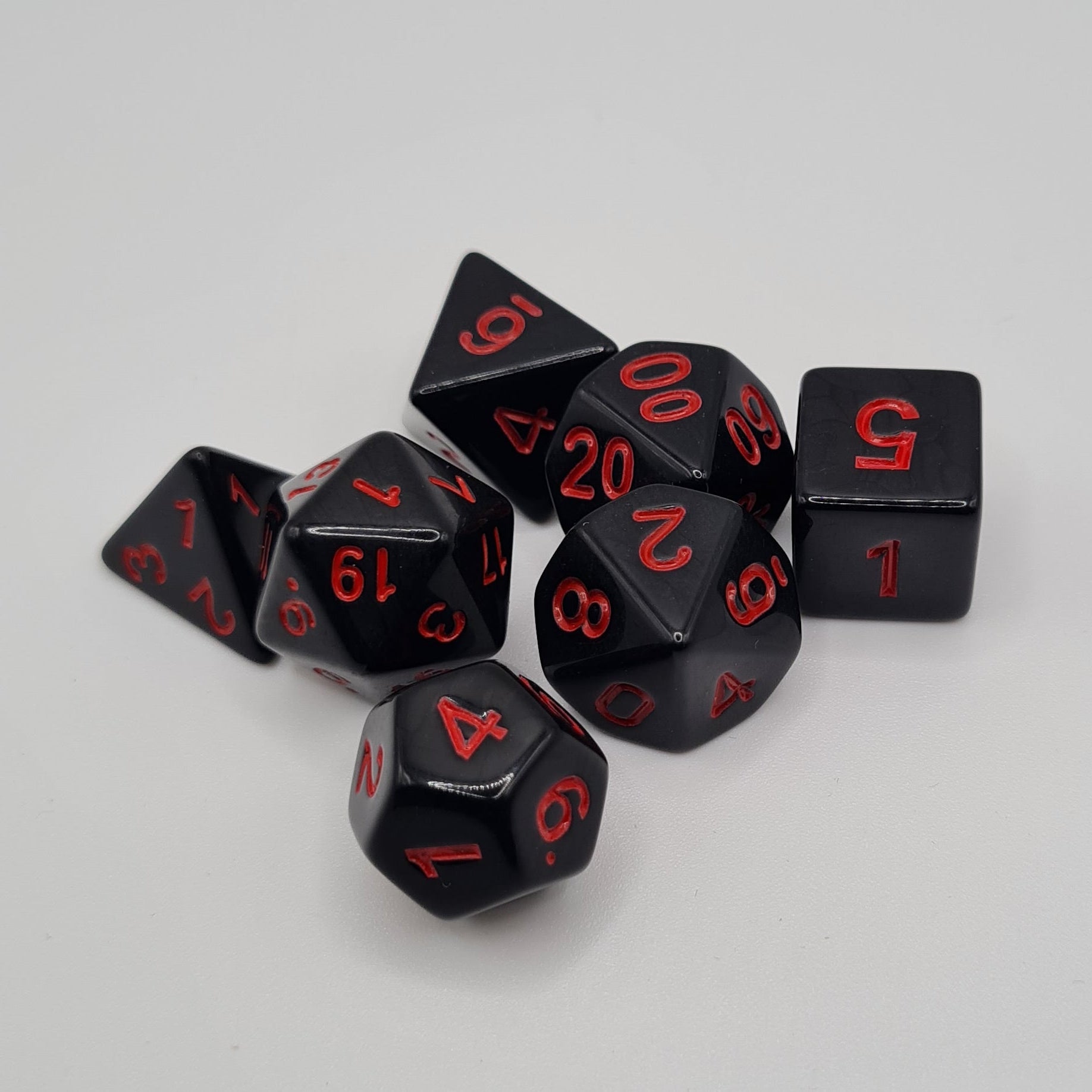 Black with Red Numbers Polyhedral Dice Set – 7-Piece Tabletop Gaming Dice with Bag